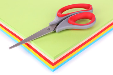 Colorful cardboard and scissors on white background