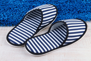 Striped slippers on floor background
