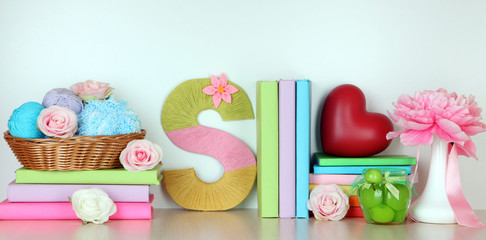 Shelf decorated with handmade knit letter