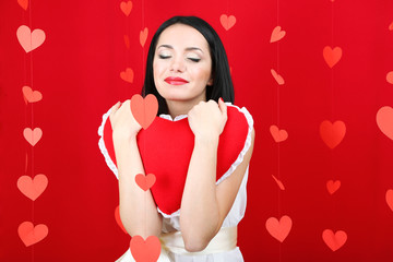 Attractive young woman with heart on Valentine Day