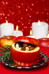 Red christmas apples stuffed with dried fruits in honey