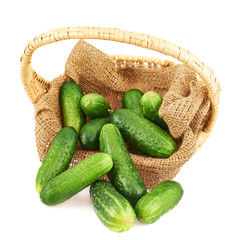 Wicker basket full of cucumbers isolated