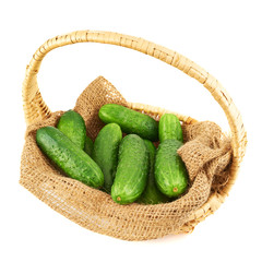 Wicker basket full of cucumbers isolated