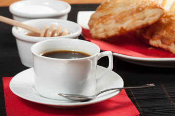 Breakfast including coffee, bread, honey.