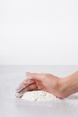 Hands and white wheat flour