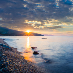 dramatic sunset over a rocky sea coast