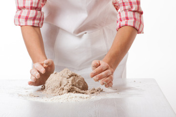 hands knead rye dough