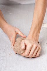 hands knead rye dough