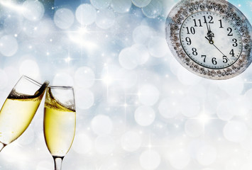 Champagne glasses and clock at midnight