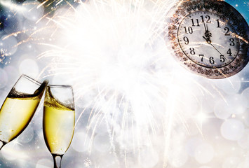 Champagne glasses and clock at midnight