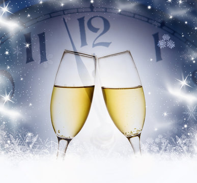 Champagne glasses and clock at midnight