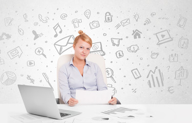 Business woman sitting at table with hand drawn media icons