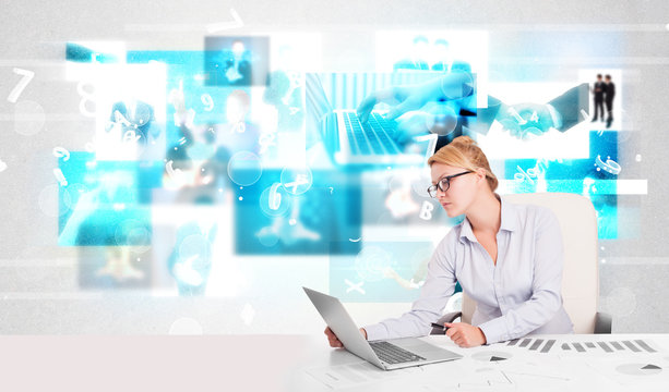 Business person at desk with modern tech images at background