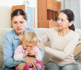 Mature woman and  mother with baby having conflict