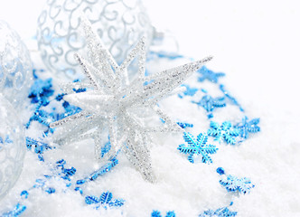 Christmas blue and silver decorations on snow