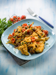 fish with fennel tomatoes and capers, selective focus