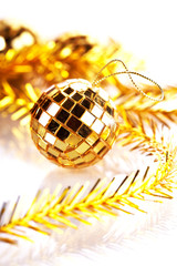 Gold mirror sphere and Christmas tinsel.