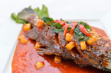 Fried snapper with chili sauce on the plate
