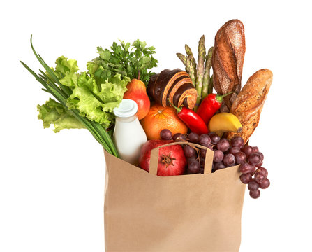 A grocery bag full of healthy fruits and vegetables