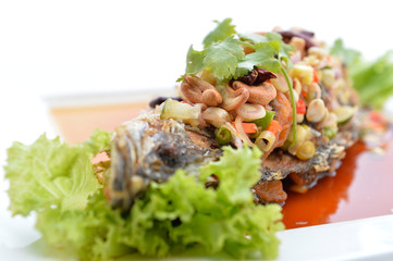 Thai food fried fish with spicy sauce isolated in white backgrou