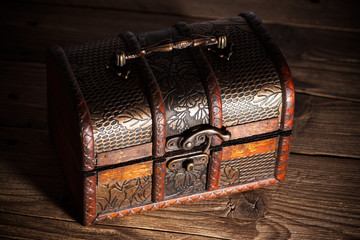 Treasure chest on wooden background