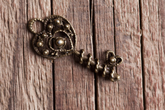 single key on wooden background