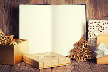 open book with christmas decoration on wooden background