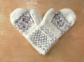 Pair of mittens in the shape of heart.