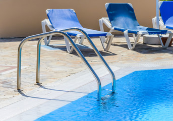a swimming pool with sun loungers