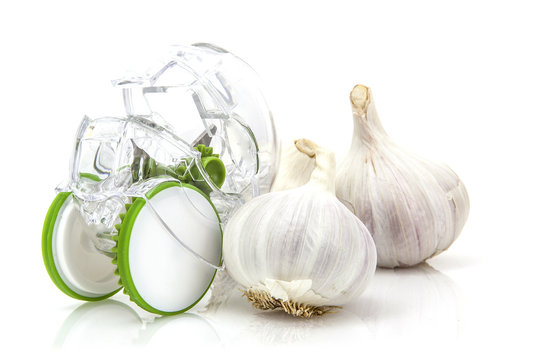 Garlic Cloves with cutter on white background