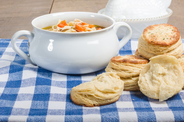 Chicken soup and biscuits on table