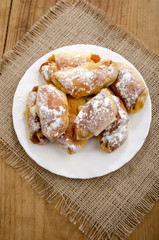 croissant with powdered sugar on a plate