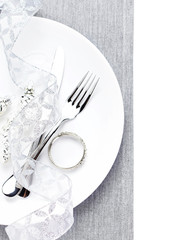 Elegant table setting place with festive decorations on white pl