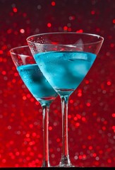 view from below of glasses of fresh blue cocktail with ice