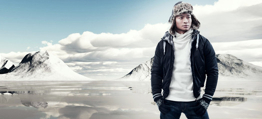 Asian winter fashion man in snow mountain landscape. Wearing bla