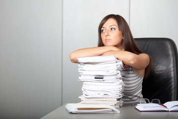 beautiful woman looking dreamingly in the office