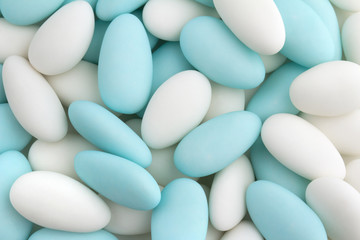 background of white and blue sugared almonds