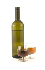 Two glasses with wine and green bottle isolated on white