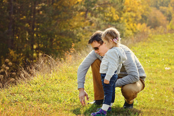 father walking with toddler daughter