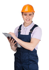 Builder in orange headpiece writing on a tablet with documents