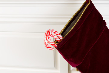 Christmas Stocking with Real Candy Canes hanging on Fireplace Ma