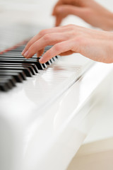 Close up view of hands playing piano