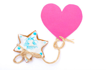 Christmas gingerbread cake star with icing decoration and heart