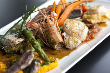 Dish with fish, lobster and various vegetables