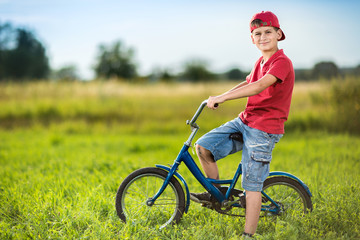 Young boy riding bicycle in a park