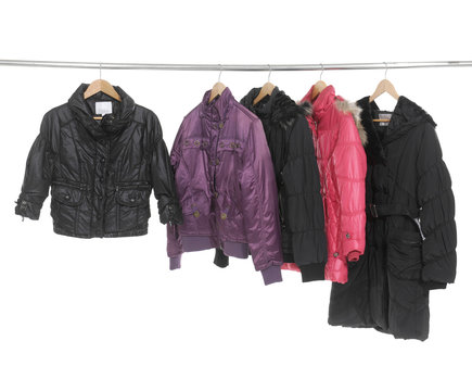 Set of colorful coat clothes hanging on clothes rack