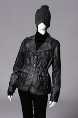 female black clothing in hat on mannequin-gray background