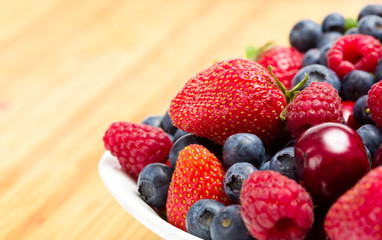Close up of plate full of berries on the table