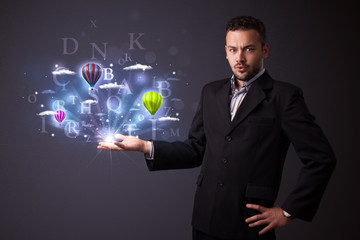 Letters and balloons in the hand of a businessman
