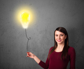 Woman holding a lightbulb balloon